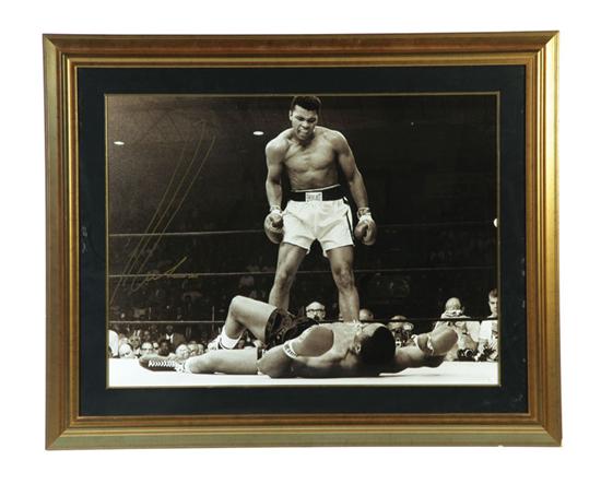 Appraisal: SIGNED MUHAMMAD ALI PHOTOGRAPH Black and white photograph showing Ali's