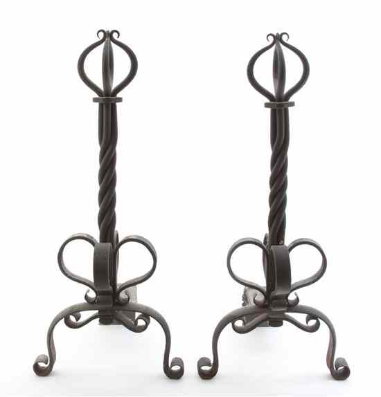 Appraisal: A Pair of Wrought Iron Andirons of stylized foliate form