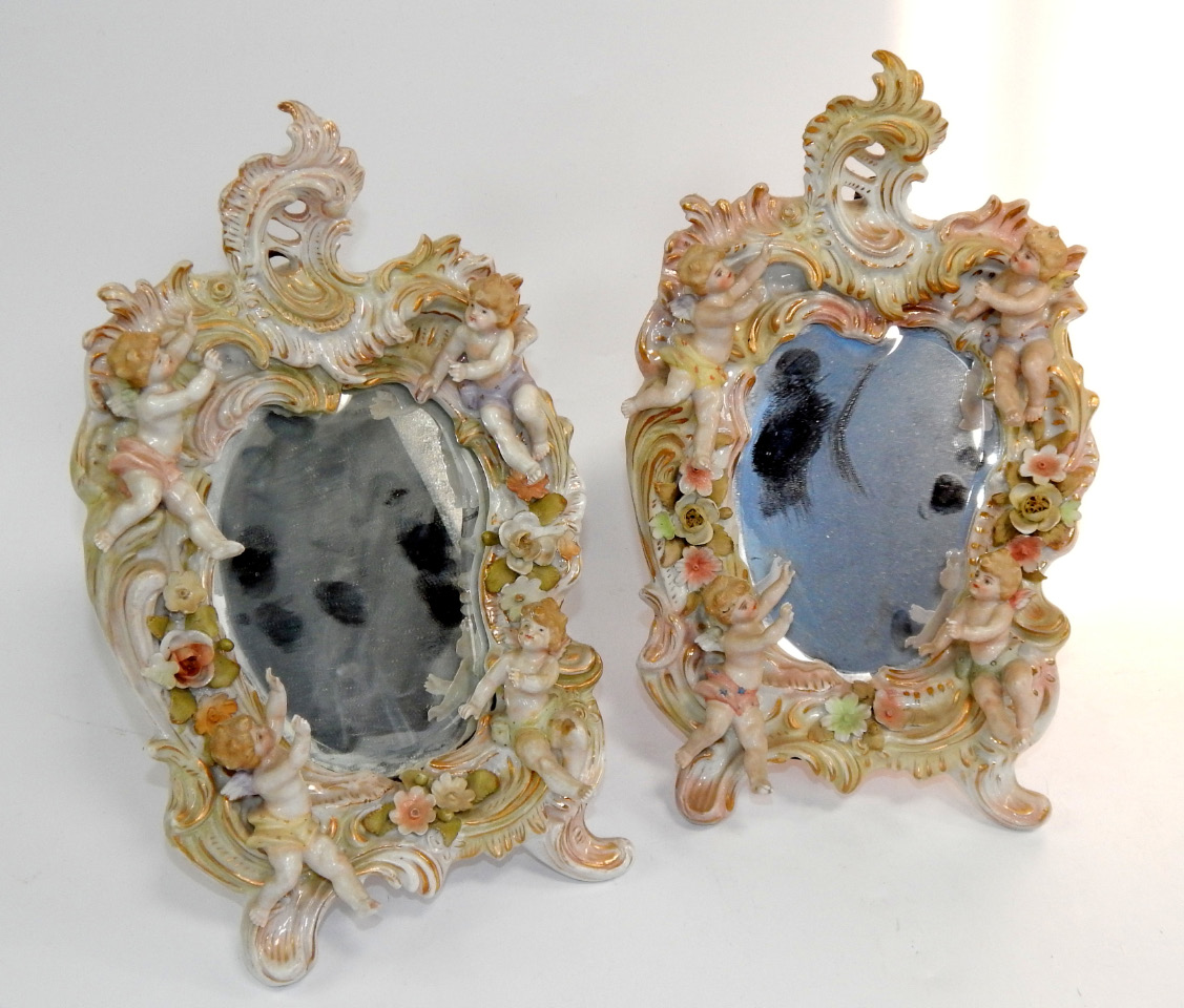 Appraisal: A pair of thC continental porcelain strut mirrors of rococo