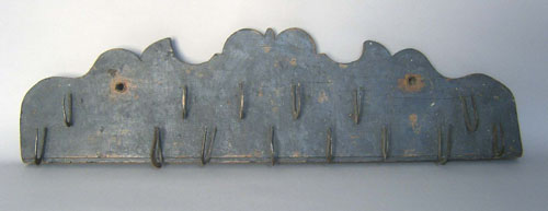 Appraisal: Iron utensil hooks th c mounted to a shaped board