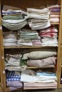 Appraisal: Four shelves of assorted table and bed linens Four shelves