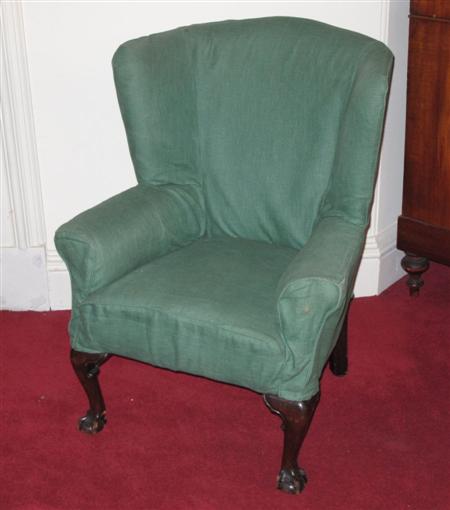 Appraisal: A th century mahogany wingback armchair the concaved cushioned back