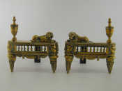 Appraisal: A pair of brass firedogs each with urn and well