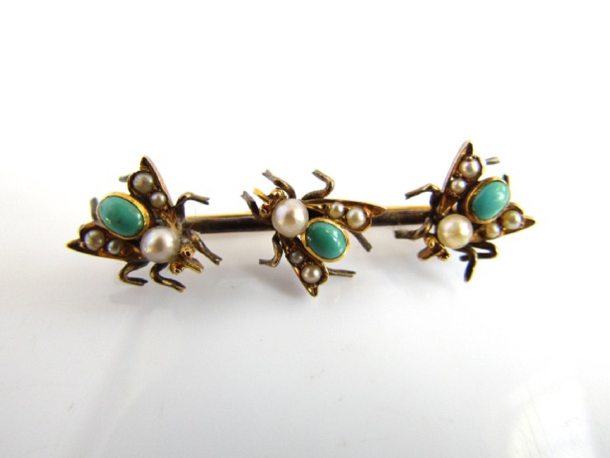 Appraisal: A turquoise and pearl bar brooch mounted with three insect