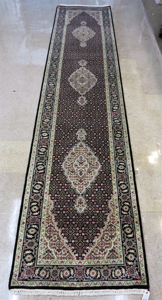 Appraisal: HAND KNOTTED ORIENTAL HALL RUG Persian Bidjar design having a