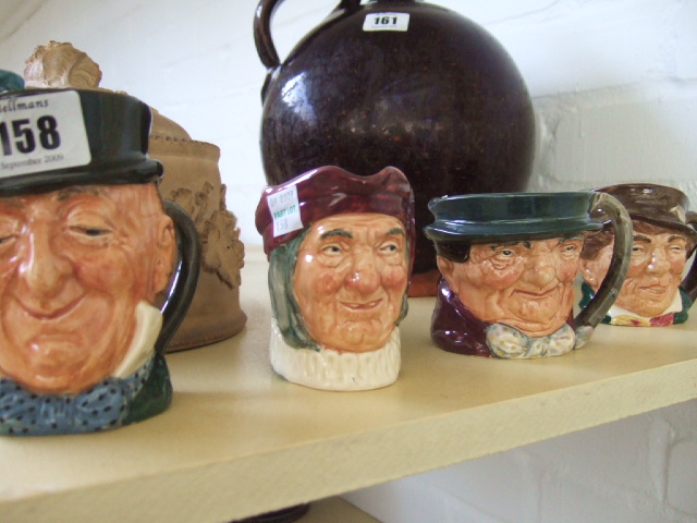 Appraisal: Four Royal Doutlon character jugs Mr Micauber Simon Celler Paddy