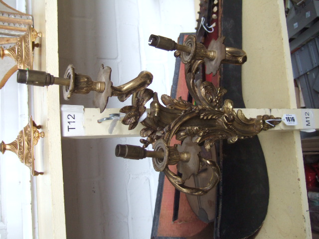 Appraisal: A pair of Rococco style brass three branch wall lights