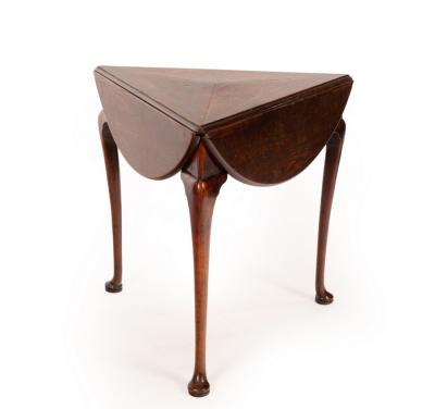 Appraisal: A George II three-legged oak drop leaf table on pad