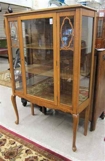 Appraisal: AN OAK QUEEN ANNE REVIVAL CHINA CABINET American c having