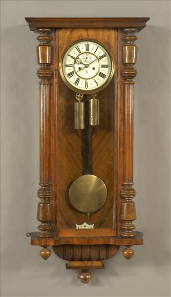 Appraisal: A walnut weight-driven Vienna style wall clock Gustave Becker late