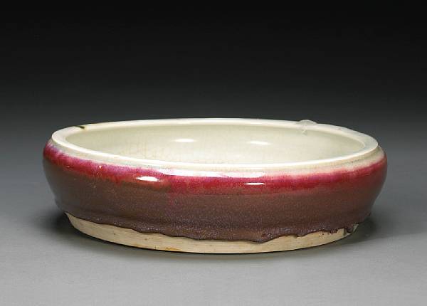 Appraisal: A transmutation red glazed porcelain basin th Century The low