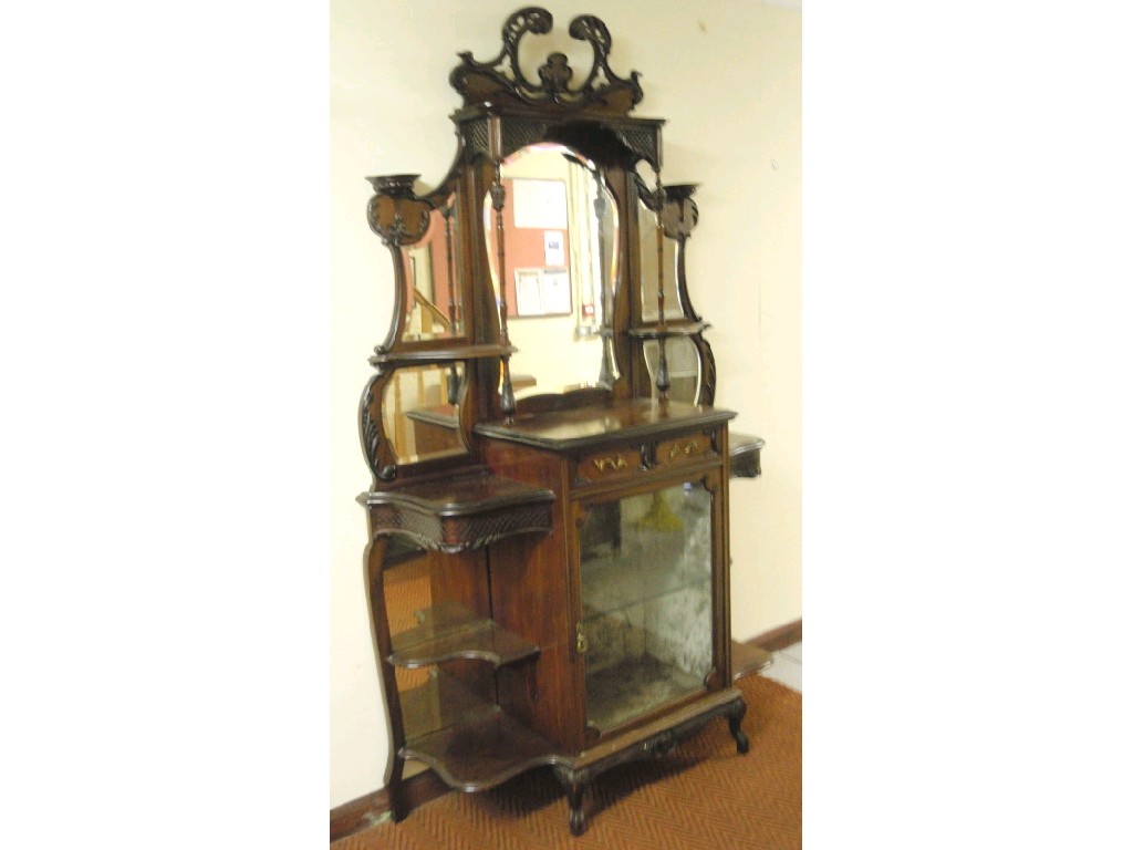 Appraisal: A late Victorian mahogany chiffonier with open fret mirrored shelved