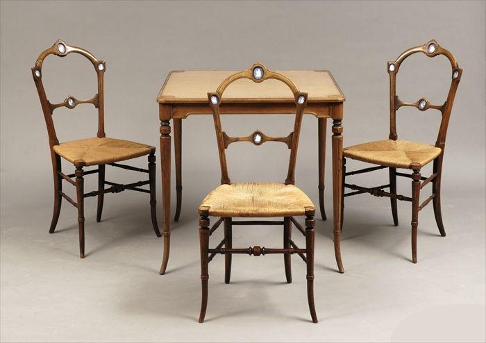 Appraisal: Victorian-Style Fruitwood Games Table and Three Porcelain-Mounted Side Chairs with