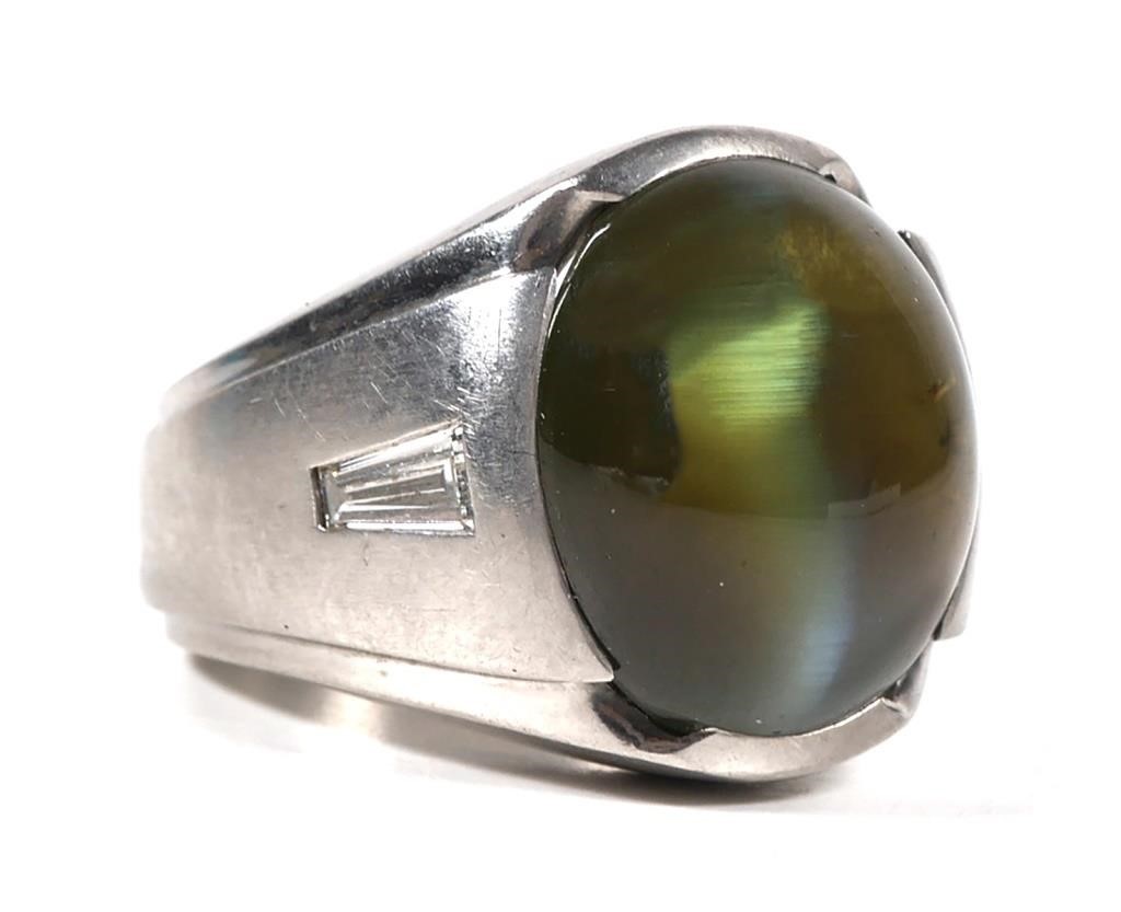 Appraisal: Size ring with large moonstone cat's eye flanked by two