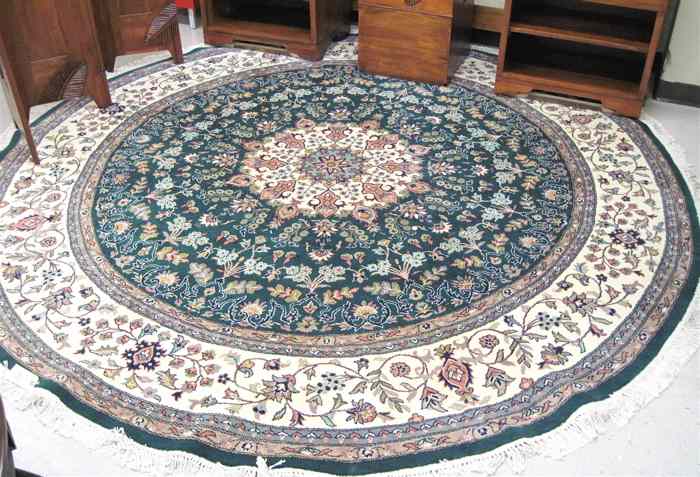 Appraisal: ROUND ORIENTAL CARPET Pakistani-Persian floral and central floral medallion design