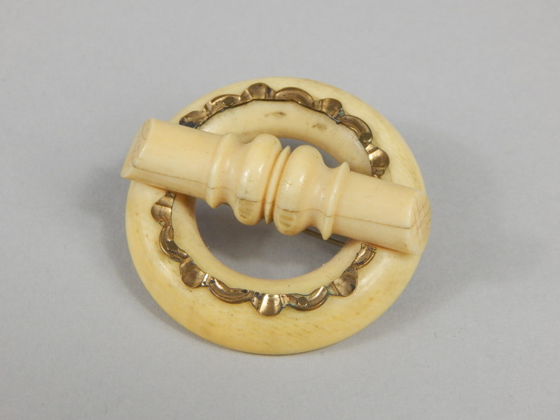 Appraisal: A Victorian ivory brooch with central circular form with gilt