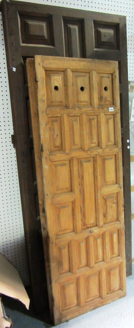 Appraisal: A large hardwood door with panelled decoration and a similar