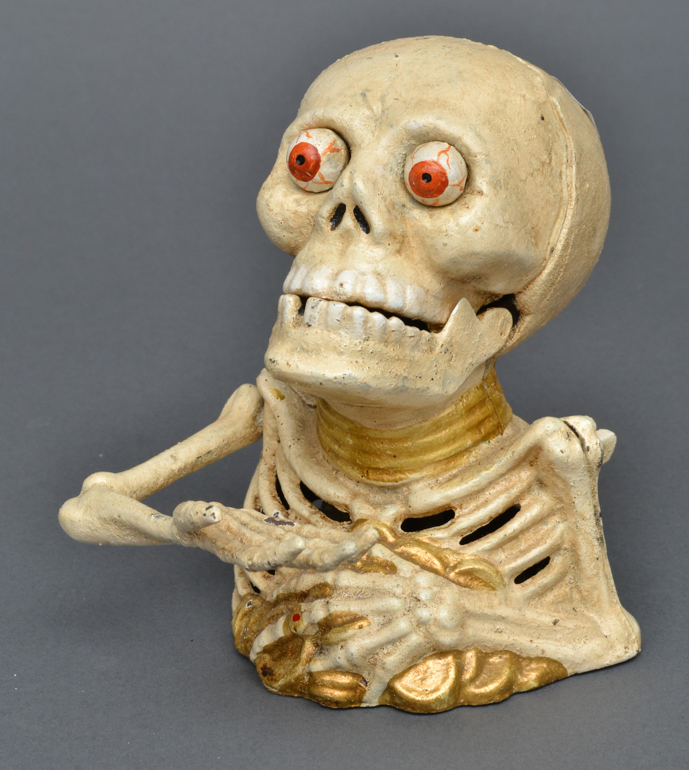 Appraisal: A WHITE PAINTED SKELETON NOVELTY MONEY BOX