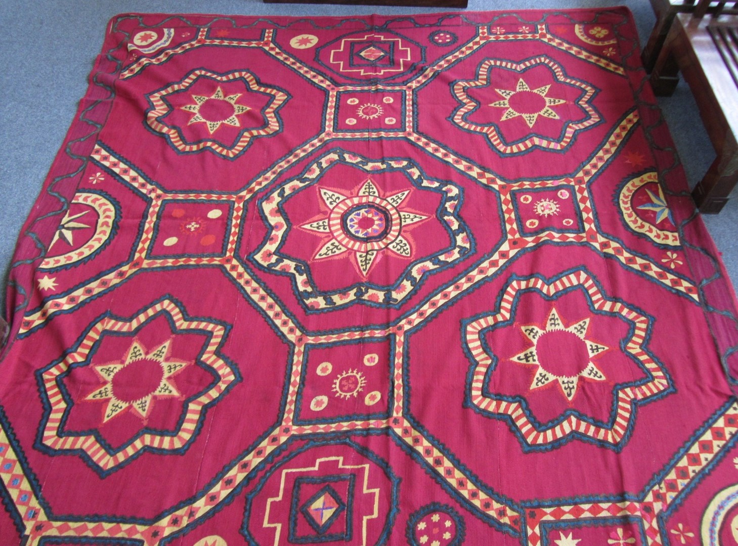 Appraisal: An embroidered Susani coverlet Uzbekistan red ground cm x cm