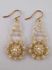 Appraisal: A pair of seed pearl drop earrings with gold fittings