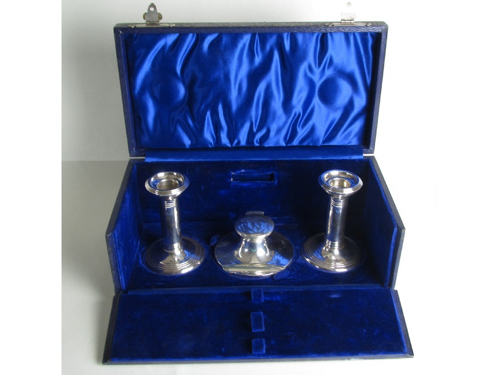 Appraisal: An Edwardian silver capstan inkwell and a pair of candl