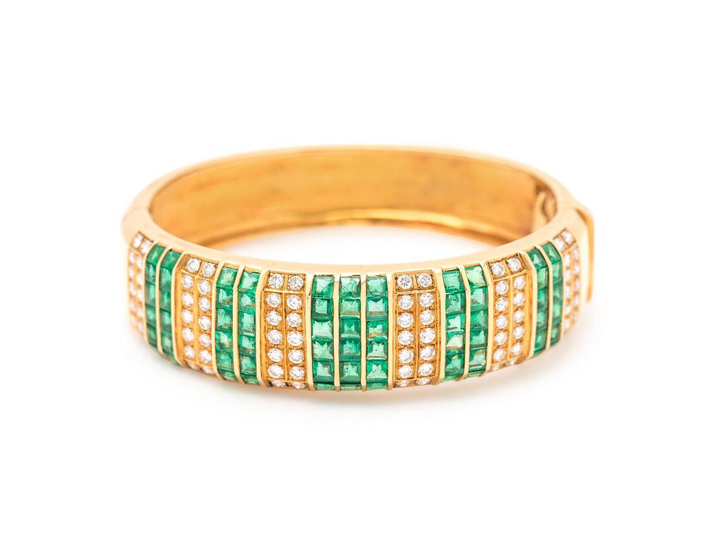 Appraisal: DIAMOND AND EMERALD BANGLE DIAMOND AND EMERALD BANGLE Containing round