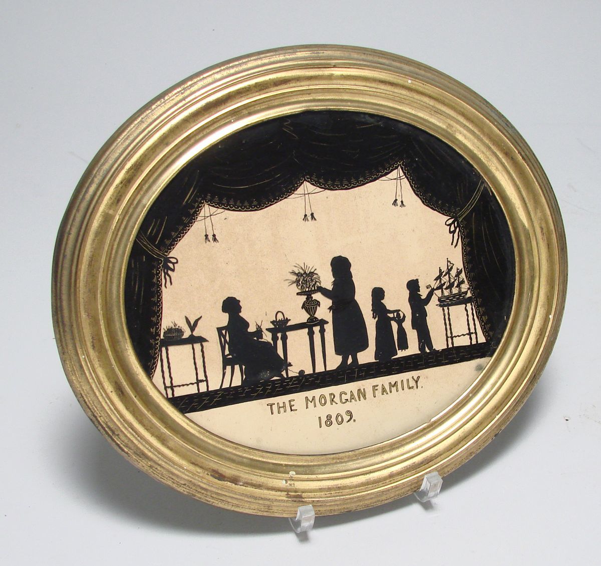 Appraisal: FRAMED OVAL REVERSE-PAINTED GLASS SILHOUETTE Dated The Morgan Family depicting