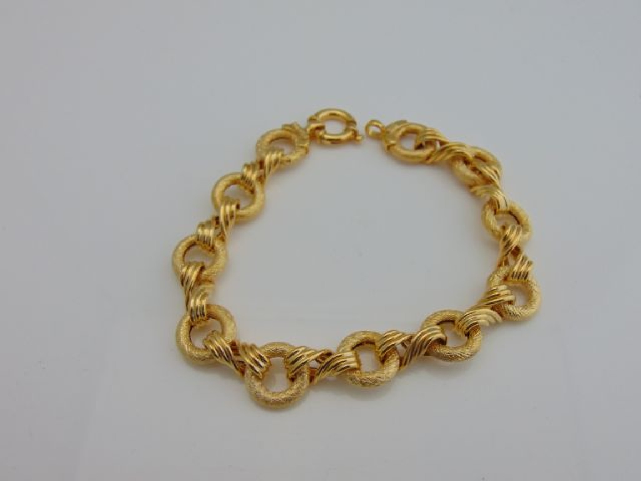 Appraisal: A ct gold bracelet composed of brushed circular links interspersed