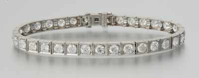 Appraisal: A Platinum and Diamond Straight-line Bracelet Platinum articulated design bracelet