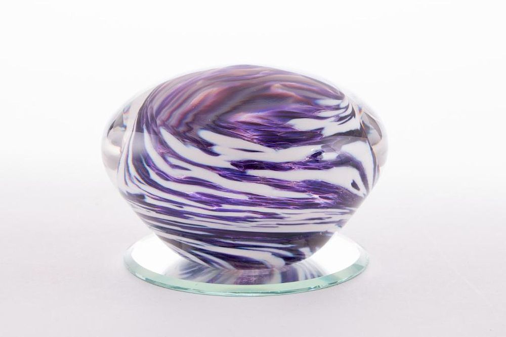 Appraisal: A glass paperweight A glass paperweight with purple and white