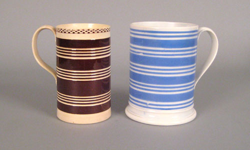 Appraisal: Two mocha mugs th c with brown and blue bands