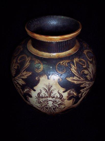 Appraisal: A Martin Bros stoneware vase with incised decoration masks issuing