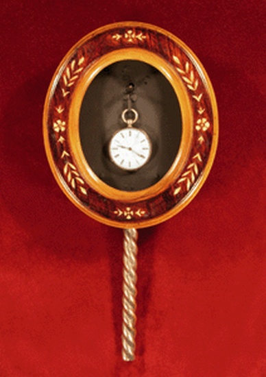 Appraisal: WATCH MIRROR A borrowed watch is seemingly placed in the