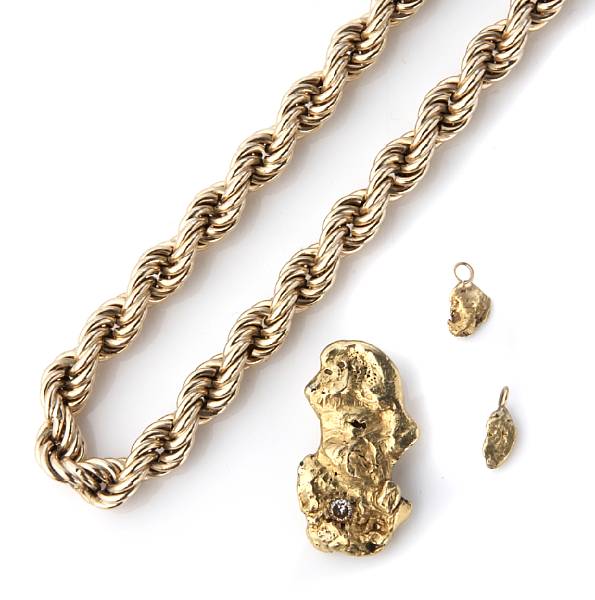 Appraisal: A collection of three gold nugget pendants one diamond set