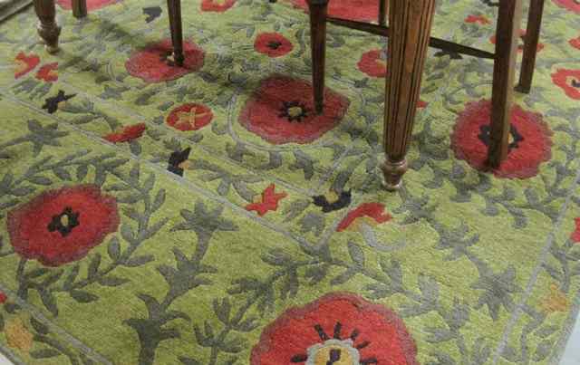 Appraisal: HAND KNOTTED NEPALESE CARPET overall red poppies design on green