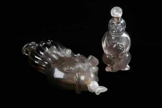 Appraisal: TWO CHINESE SMOKEY QUARTZ SNUFF BOTTLES One carved to depict