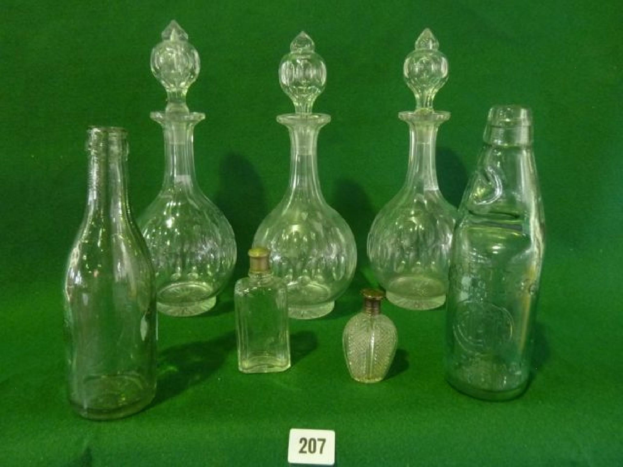 Appraisal: Three glass decanters with slice cut hollow stoppers facet cut