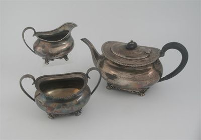 Appraisal: A modern three-piece tea service oval with gadrooned rims paw