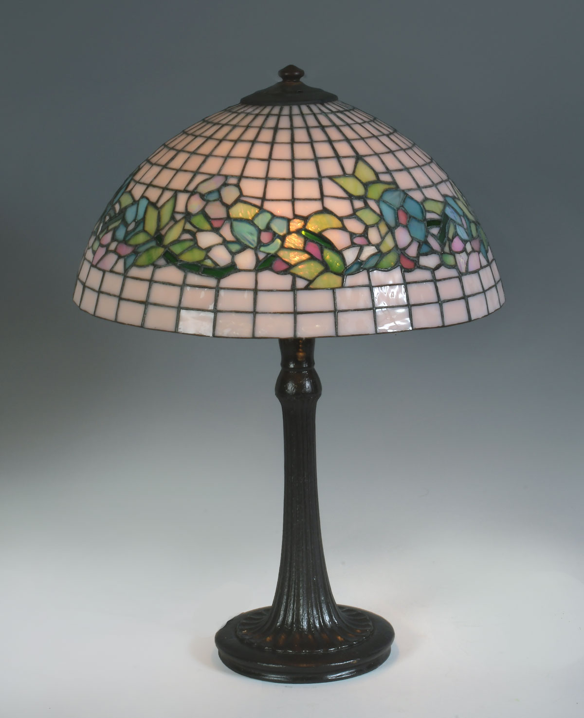 Appraisal: HANDEL STYLE FLORAL MOTIF LEADED LAMP - Light patinated metal