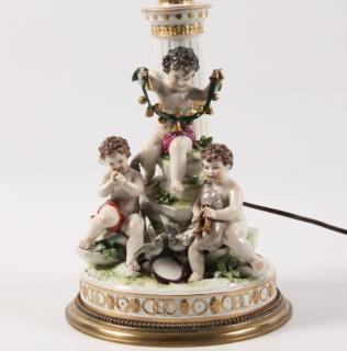 Appraisal: GERMAN PORCELAIN FIGURE OF CHERUB AND PUTTI PLAYING MUSIC WITH