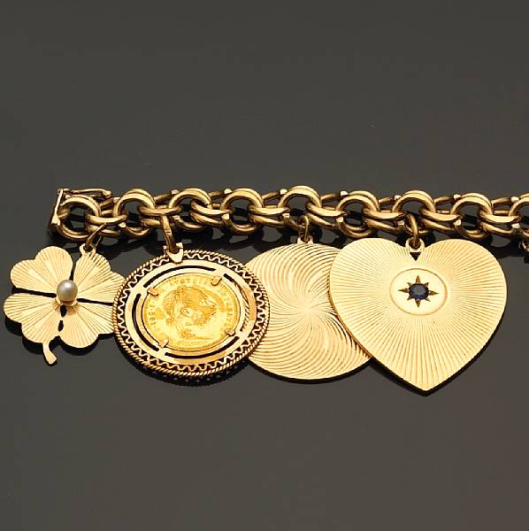 Appraisal: A charm bracelet suspending seven charms gross weight approximately grams