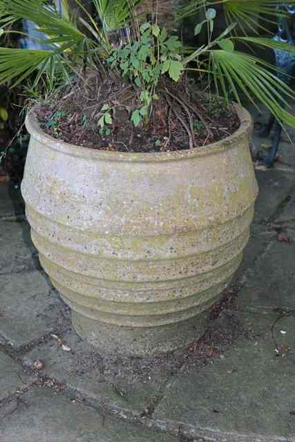 Appraisal: A PAIR OF OVOID TERRACOTTA PLANTERS with ribbed decoration high