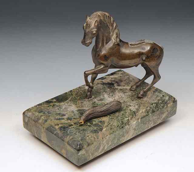 Appraisal: A CAST BRONZE MODEL of a stallion standing on a