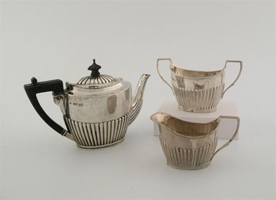 Appraisal: A Victorian three piece bachelor's tea set with part-fluted oval