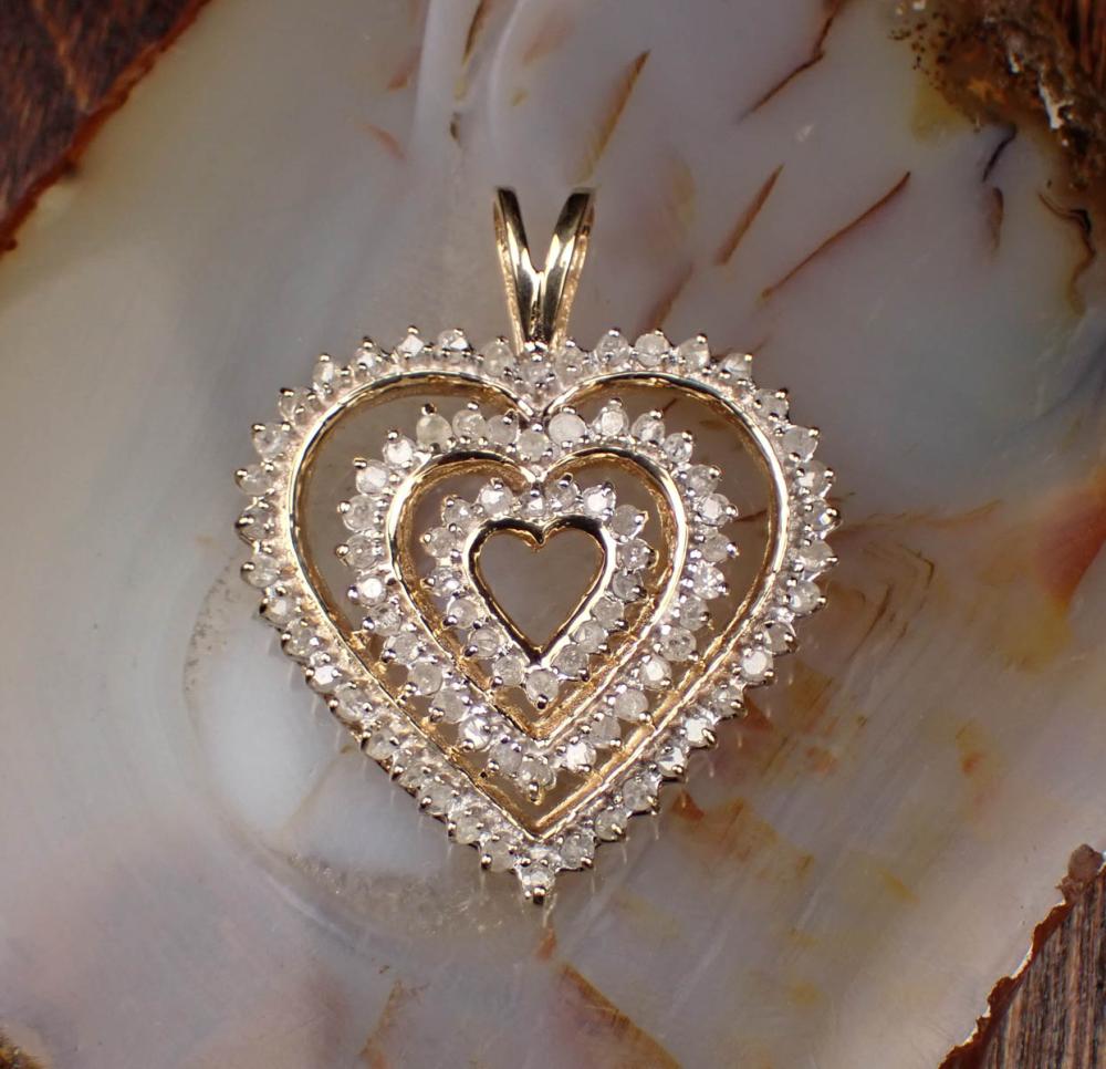 Appraisal: DIAMOND AND YELLOW GOLD TRIPLE-HEART PENDANT The k yellow gold