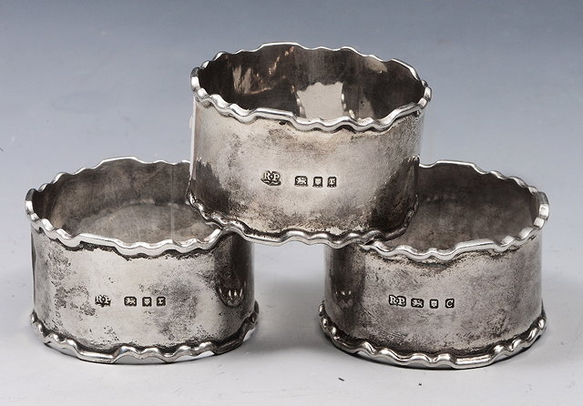 Appraisal: A SET OF THREE SILVER NAPKIN RINGS with Chippendale style