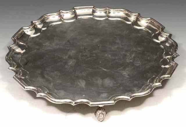 Appraisal: AN EDWARDIAN SILVER SALVER with a Chippendale border and standing