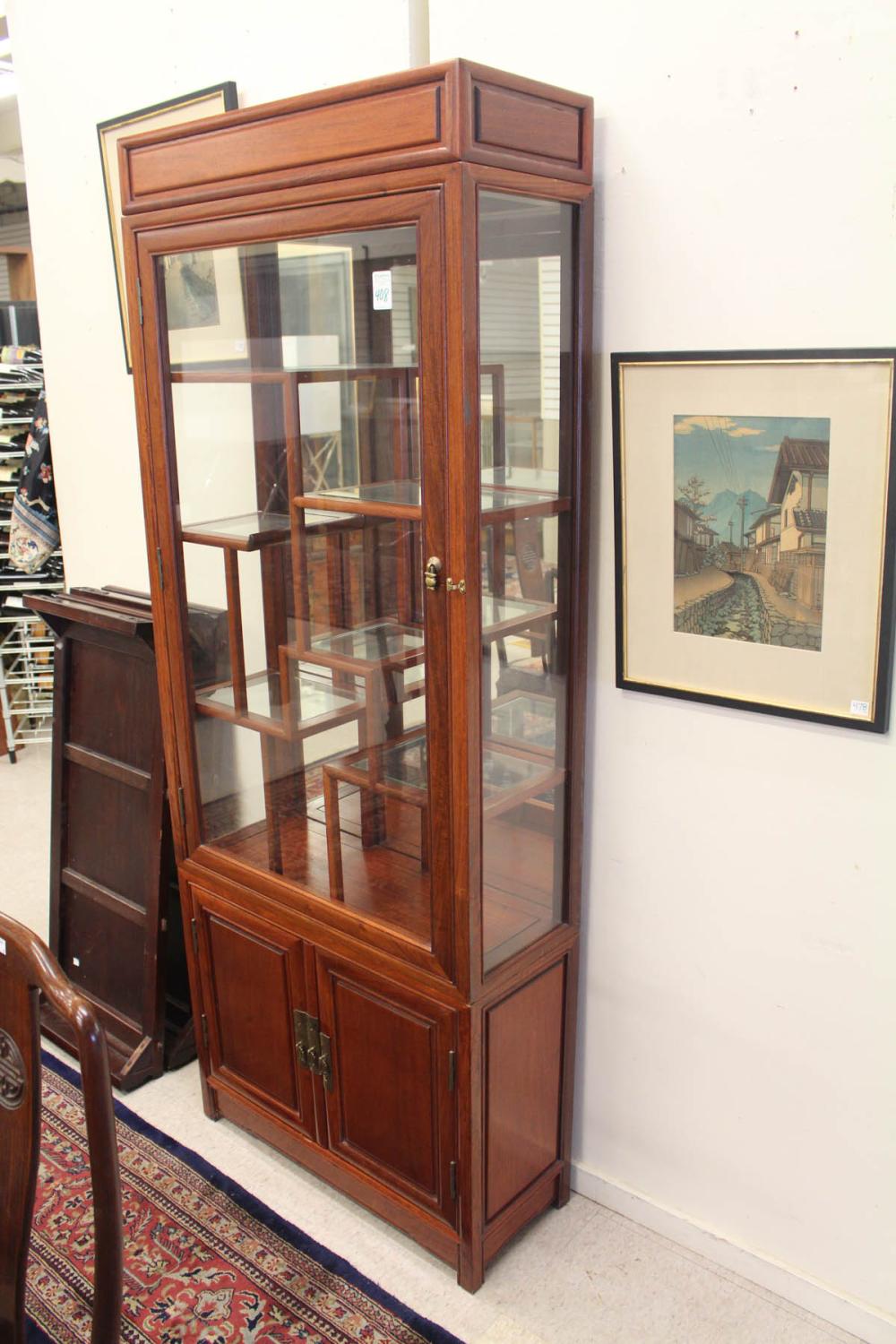 Appraisal: CHINESE ROSEWOOD AND GLASS CURIO CABINET ON CABINET six levels