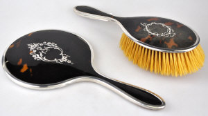 Appraisal: A silver tortoiseshell and pique hand-mirror and hairbrush Mappin Webb