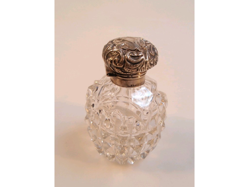 Appraisal: An Edwardian glass scent bottle with silver mount and emboss